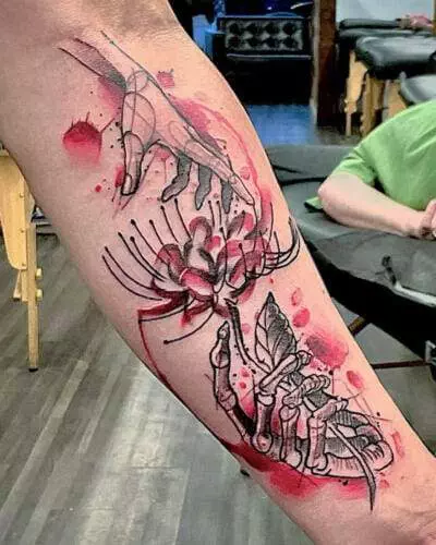 A detailed tattoo on an arm depicts skeletal hands reaching towards a blooming flower with red splatters in the background.