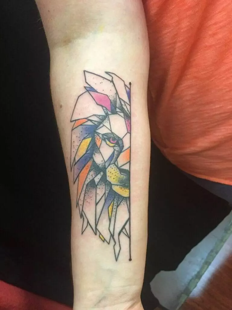 Forearm tattoo featuring a stylized geometric bird with vibrant pastel colors, including pink, yellow, and orange, set against a black outline.